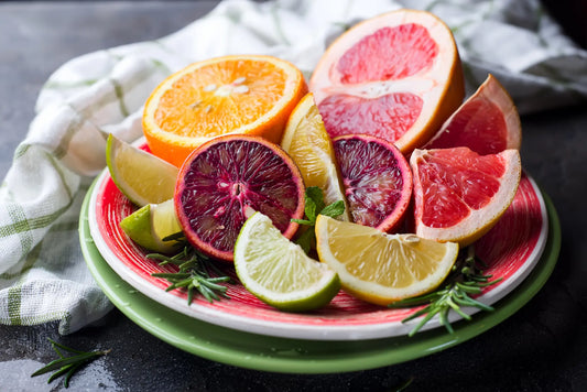 Assorted citrus fruits on a plate - a great source of flavonoids such as quercetin for a healthy diet.